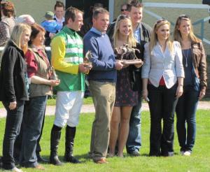 Students, along with Dungarvan's mayor and his wife, hand the winning jockey of the horse race his trophy. Students include Caileen Farrell, Melissa Kirwin and Sarah Hricko.
